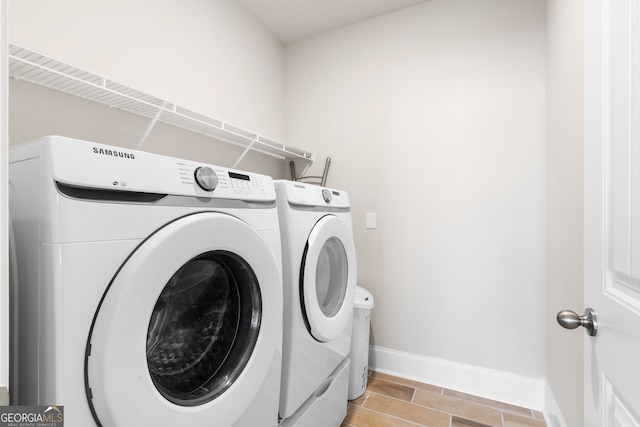 laundry room with washing machine and clothes dryer