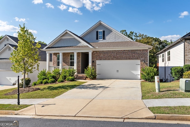 craftsman-style house with a front yard, covered porch, and a garage