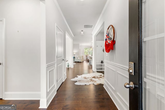 hallway featuring ornamental molding and dark wood-type flooring