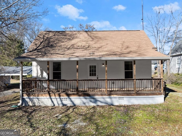 back of property with a porch