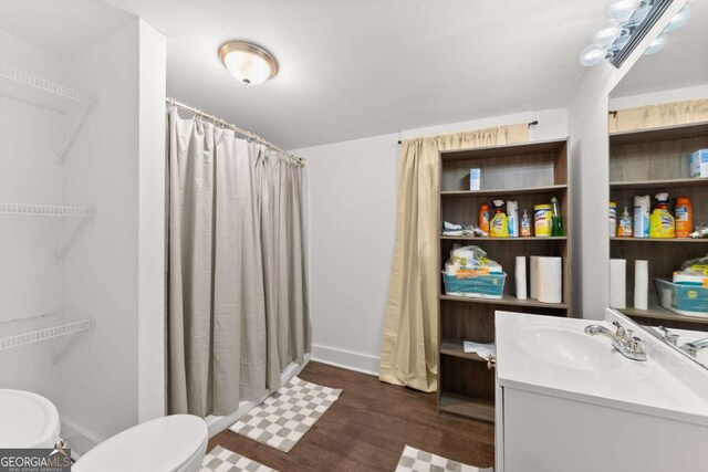 bathroom featuring toilet, a shower with curtain, wood-type flooring, and vanity