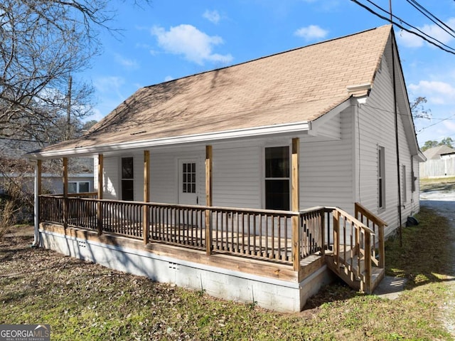 back of property with a shingled roof