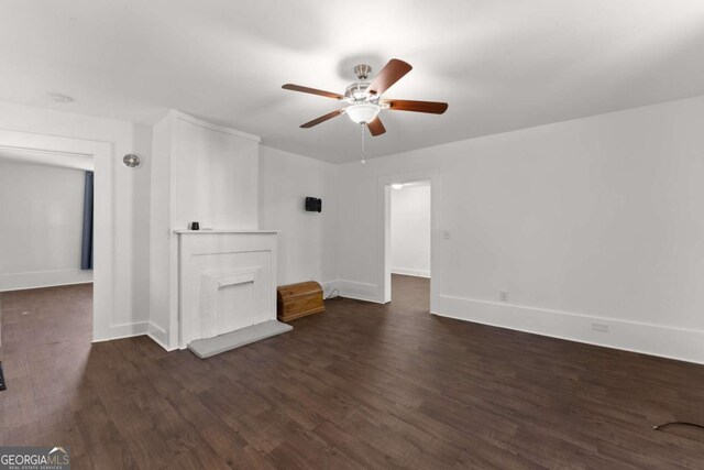 empty room with ceiling fan and dark wood-type flooring