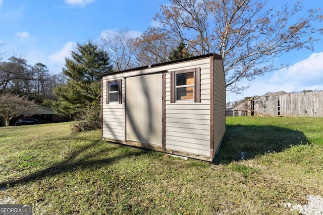 view of outbuilding with a lawn