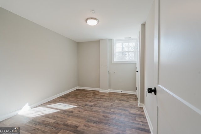 spare room featuring wood finished floors and baseboards