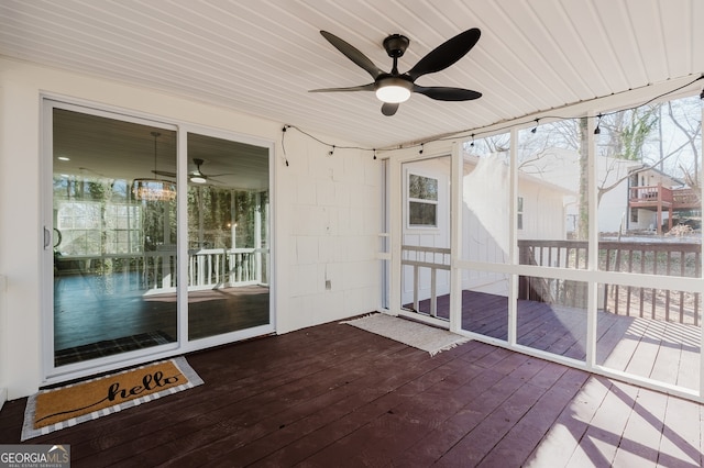 unfurnished sunroom with ceiling fan