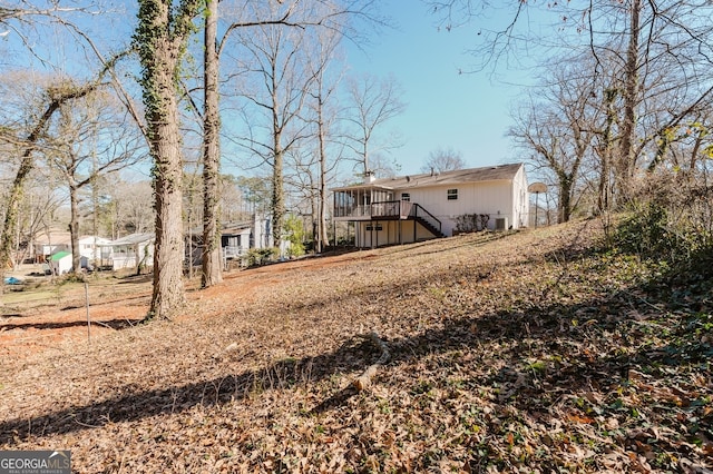 rear view of property with a deck and stairs