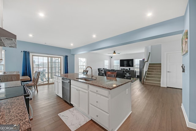 kitchen with sink, white cabinetry, ceiling fan, an island with sink, and stainless steel dishwasher