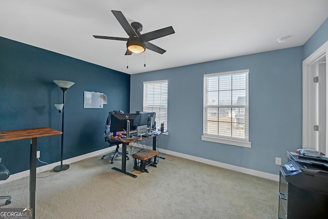 carpeted office space featuring ceiling fan