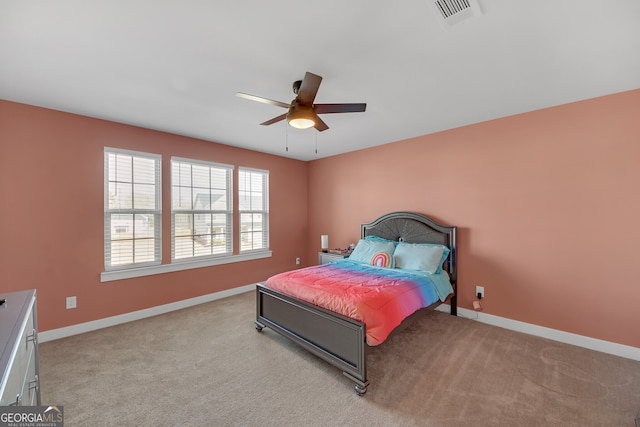 bedroom with ceiling fan and light carpet