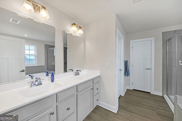 bathroom featuring vanity, hardwood / wood-style flooring, and shower with separate bathtub