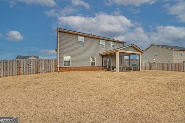 back of house with a yard and a sunroom