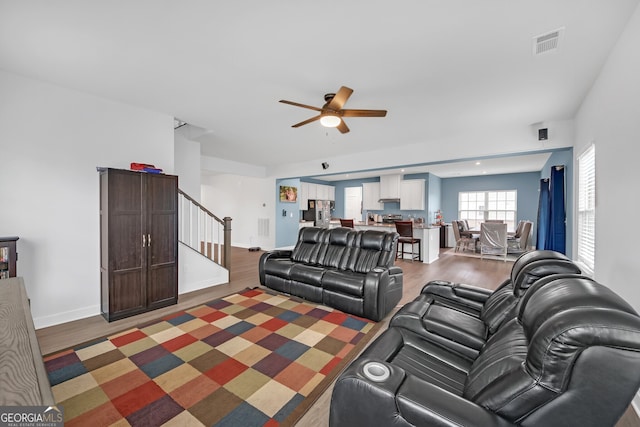 living room with ceiling fan and hardwood / wood-style flooring