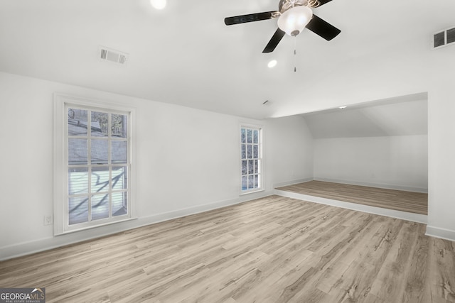 bonus room featuring ceiling fan, a healthy amount of sunlight, light hardwood / wood-style flooring, and vaulted ceiling