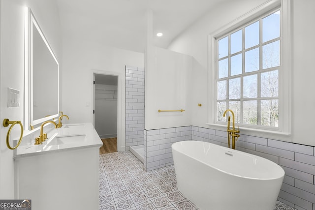 bathroom with tile walls, tile patterned flooring, plus walk in shower, and plenty of natural light