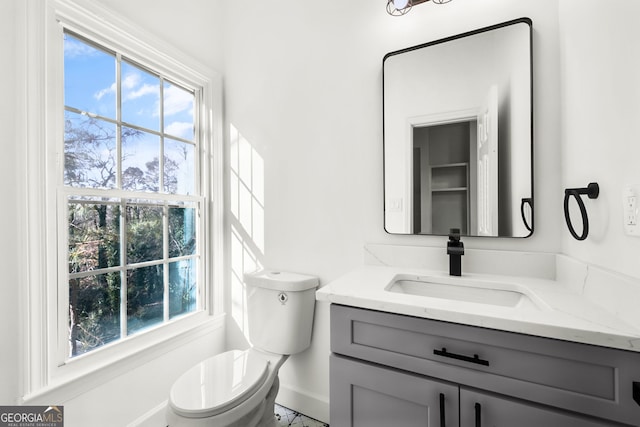 bathroom with toilet and vanity