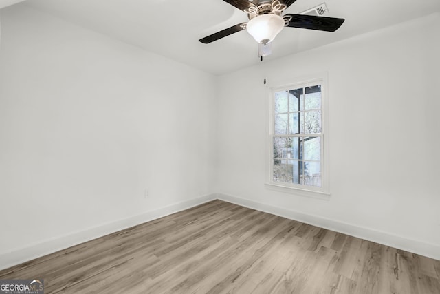 empty room featuring ceiling fan and light hardwood / wood-style flooring