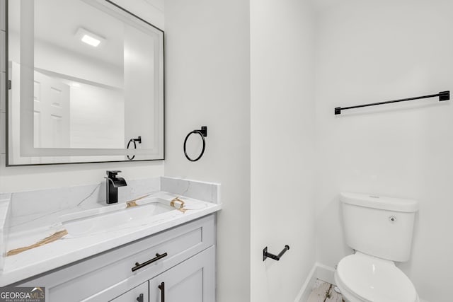 bathroom featuring toilet and vanity