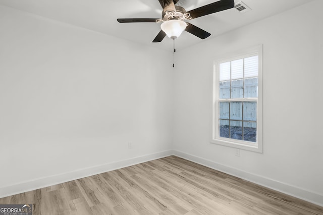 empty room with ceiling fan and light wood-type flooring