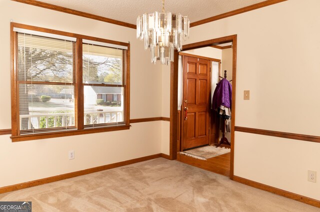 114 Tracy Ln, Mcdonough, GA 30253 - spare room with crown molding, a textured ceiling, light carpet, a wealth of natural light, and a notable chandelier