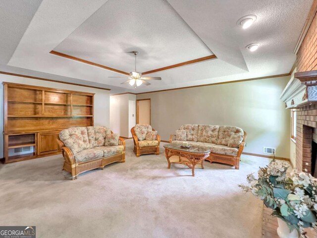 114 Tracy Ln, Mcdonough, GA 30253 - living room featuring a tray ceiling, crown molding, light colored carpet, and a textured ceiling