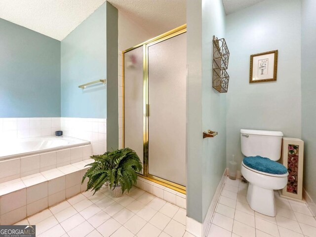 114 Tracy Ln, Mcdonough, GA 30253 - bathroom featuring tile patterned floors, toilet, a garden tub, a shower stall, and a textured ceiling