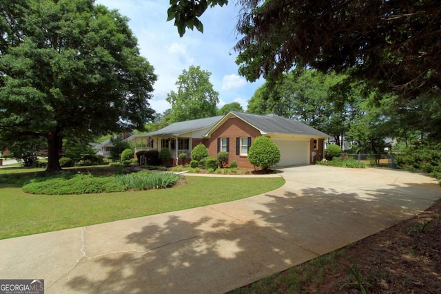 114 Tracy Ln, Mcdonough, GA 30253 - view of front of house with brick siding, a front yard, driveway, and an attached garage