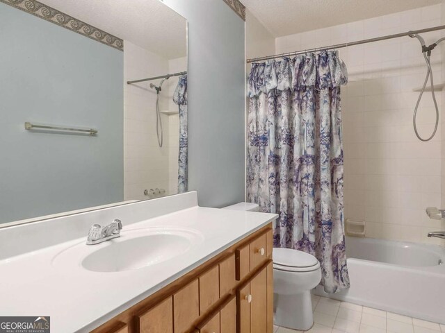 full bathroom with toilet, a textured ceiling, shower / tub combo, and vanity