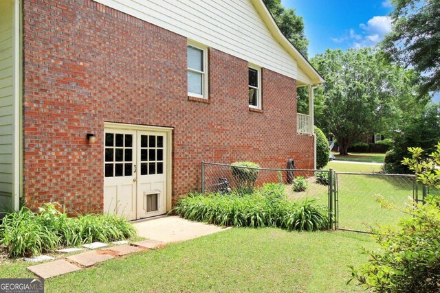 114 Tracy Ln, Mcdonough, GA 30253 - view of property exterior with a lawn, brick siding, fence, and a gate