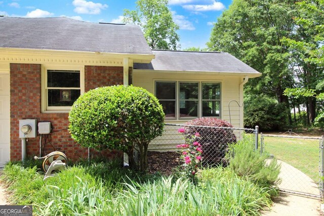 114 Tracy Ln, Mcdonough, GA 30253 - exterior space featuring brick siding, a shingled roof, and fence