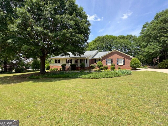114 Tracy Ln, Mcdonough, GA 30253 - ranch-style home featuring driveway, a front yard, a porch, and brick siding