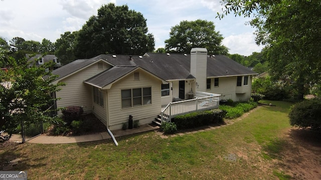 114 Tracy Ln, Mcdonough, GA 30253 - rear view of house featuring a lawn, a chimney, and a wooden deck