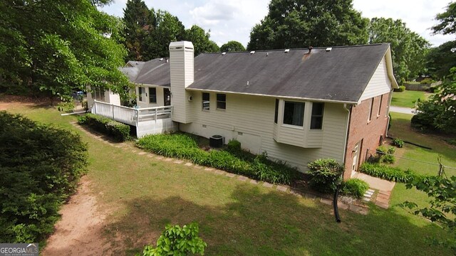 114 Tracy Ln, Mcdonough, GA 30253 - rear view of property with a lawn, a chimney, and cooling unit