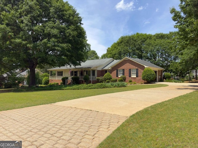 114 Tracy Ln, Mcdonough, GA 30253 - ranch-style house with a front yard, a porch, concrete driveway, brick siding, and a garage