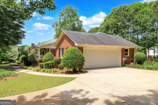 114 Tracy Ln, Mcdonough, GA 30253 - view of front of property with a chimney, a garage, brick siding, a front lawn, and driveway
