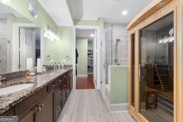 bathroom featuring an enclosed shower, tile patterned floors, and vanity