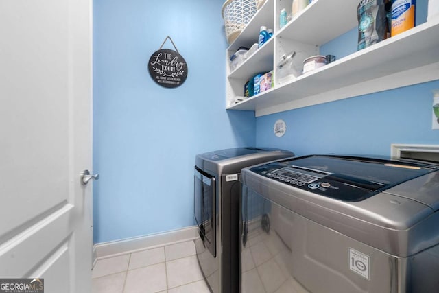 laundry room featuring light tile patterned flooring and independent washer and dryer