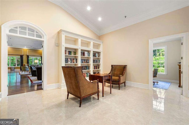 sitting room featuring crown molding and lofted ceiling