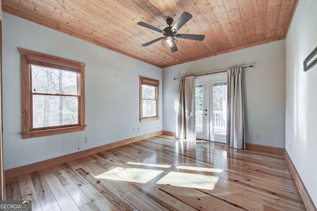 spare room with wooden ceiling, french doors, light wood-type flooring, ceiling fan, and ornamental molding