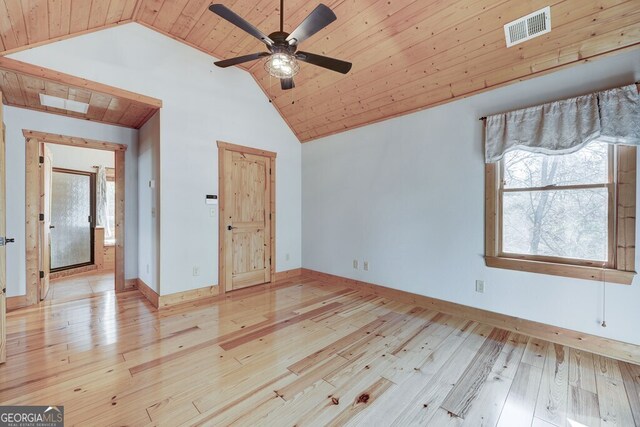 unfurnished bedroom featuring light hardwood / wood-style floors, wooden ceiling, ceiling fan, and vaulted ceiling