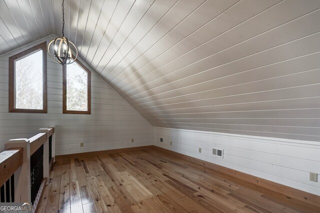 bonus room featuring vaulted ceiling and wood-type flooring