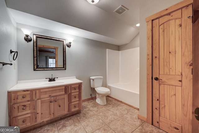 full bathroom with vanity, vaulted ceiling, toilet, tile patterned floors, and shower / washtub combination