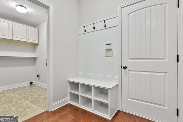 mudroom with a textured ceiling and hardwood / wood-style flooring