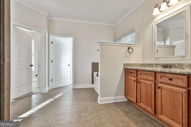 bathroom featuring tile patterned flooring, ornamental molding, a tub to relax in, and vanity