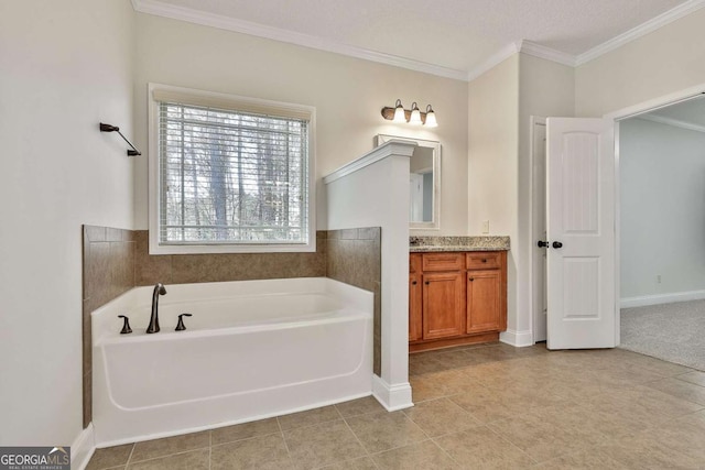 bathroom with ornamental molding, a tub to relax in, tile patterned flooring, and vanity