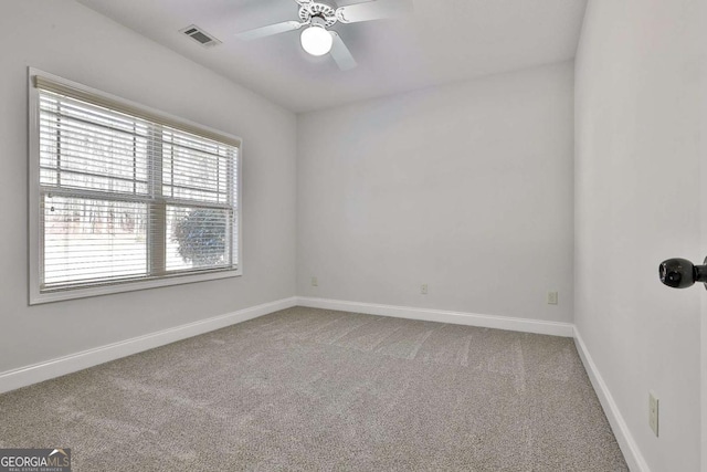 empty room featuring carpet floors and ceiling fan