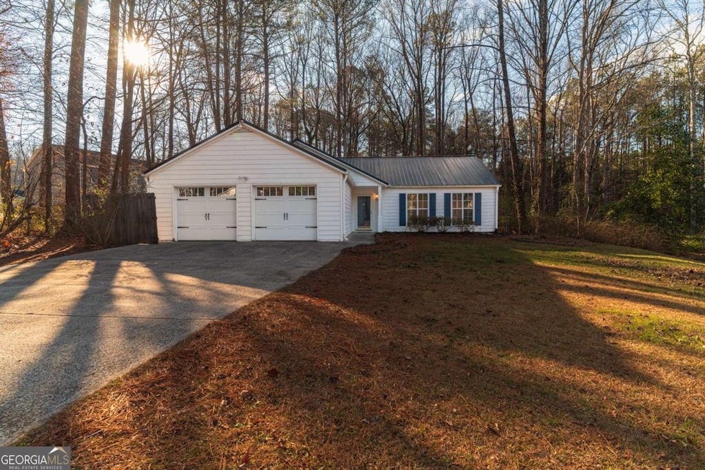 single story home with a front yard and a garage