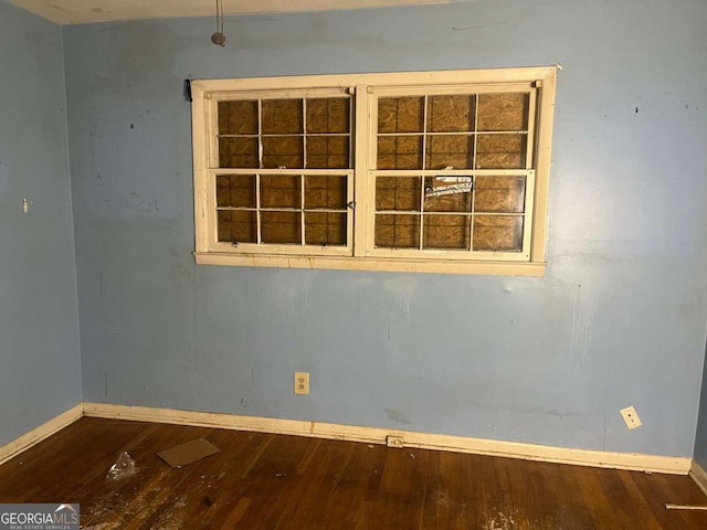 unfurnished room featuring hardwood / wood-style flooring