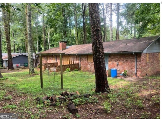 view of side of property with a yard