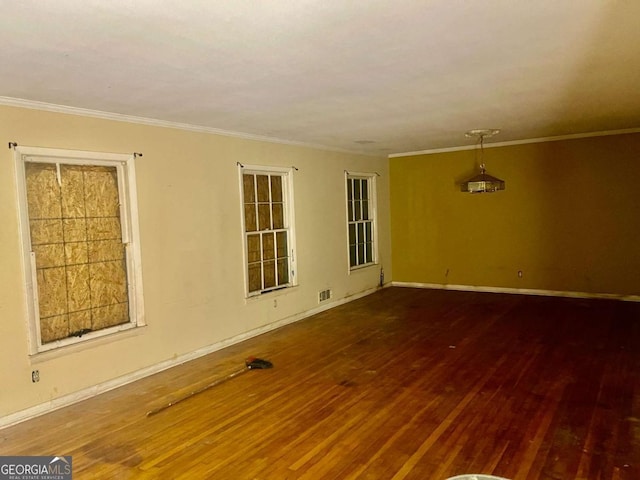 unfurnished room with ornamental molding and hardwood / wood-style floors